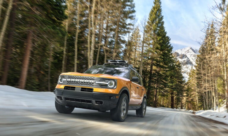2024 Ford Bronco Exterior Driving Head On In Snowy Mountain Forest